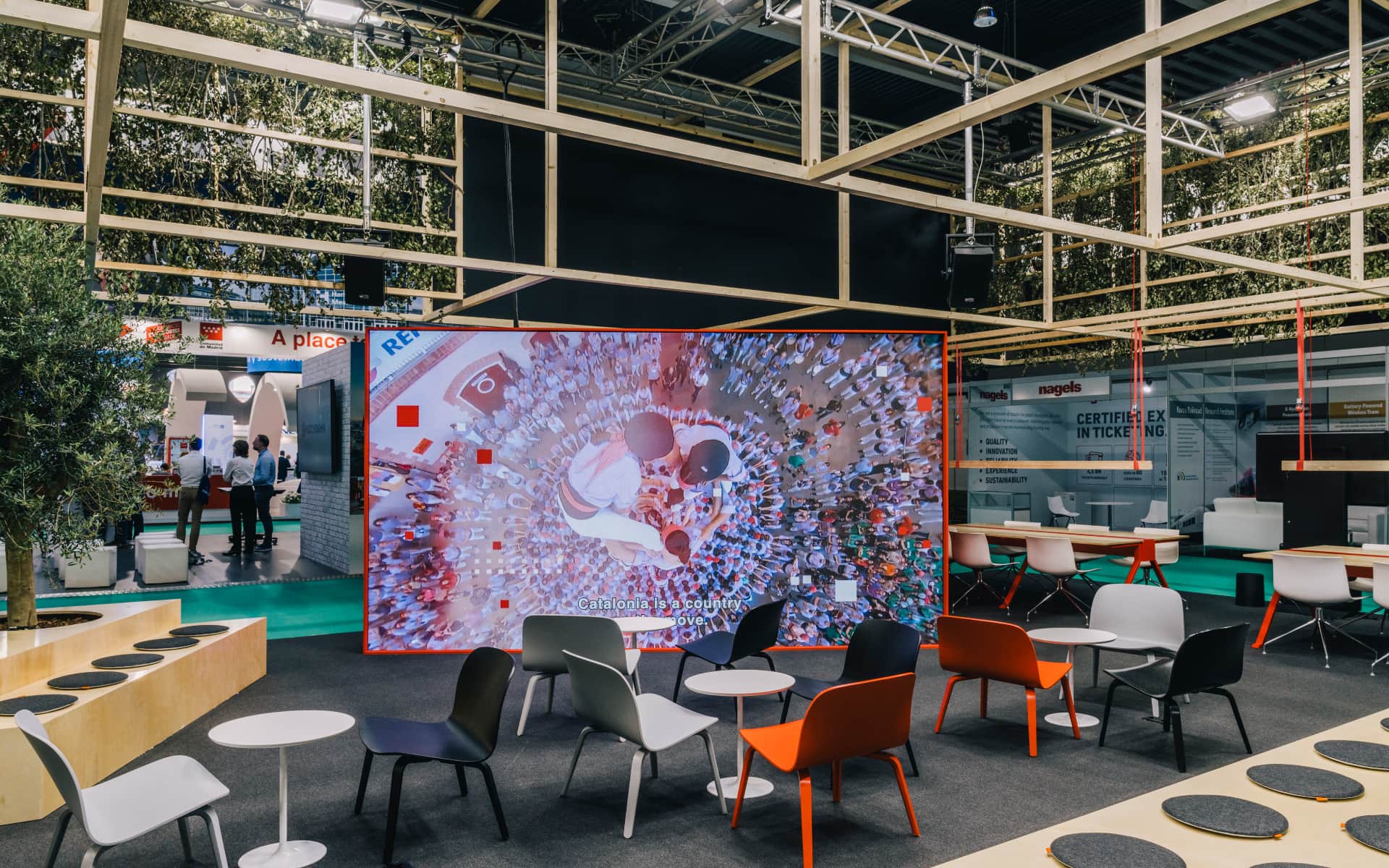 Foyer with videowall displaying human towers in Catalonia stand UTIP