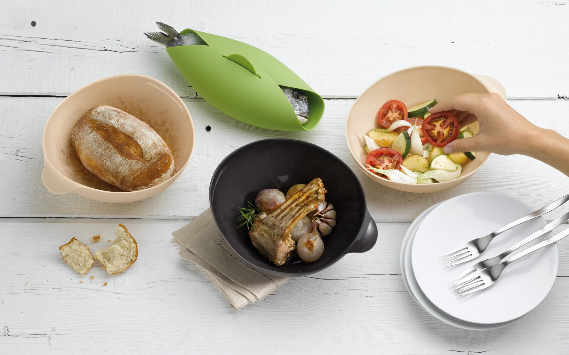 Table set with four silicone cooking bowls.